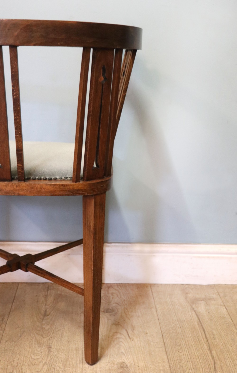A pair of antique mahogany corner chairs featuring boxwood line inlay, pierced back splats, cross-braced legs, and green upholstered seats with stud trim. View XXVII