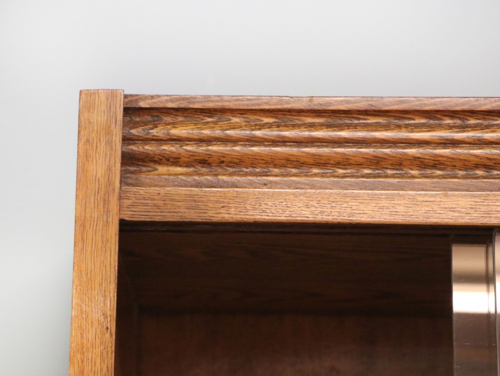  A 1930s/ 1940s oak bookcase or display cabinet decorated with the Associated Television logo. View III