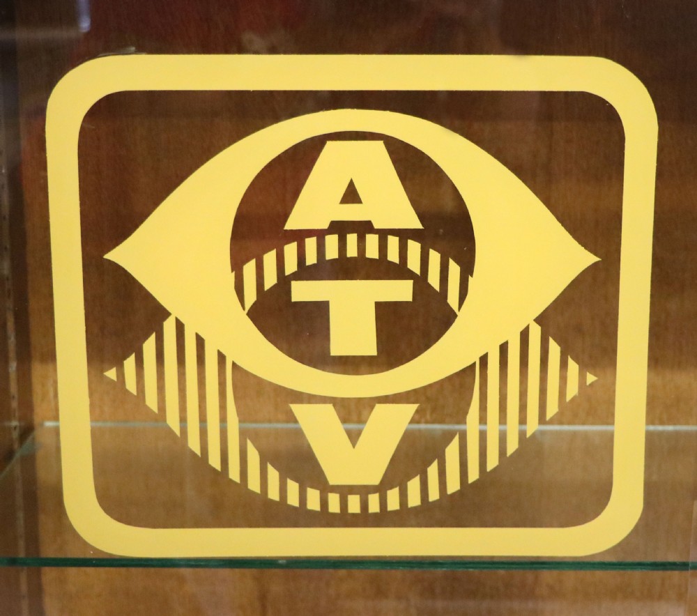  A 1930s/ 1940s oak bookcase or display cabinet decorated with the Associated Television logo. View IV