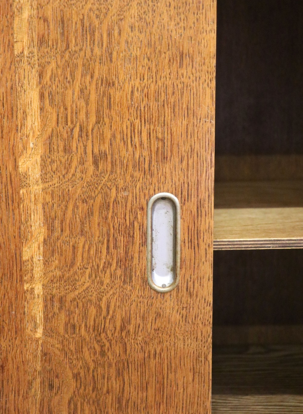  A 1930s/ 1940s oak bookcase or display cabinet decorated with the Associated Television logo. View XI