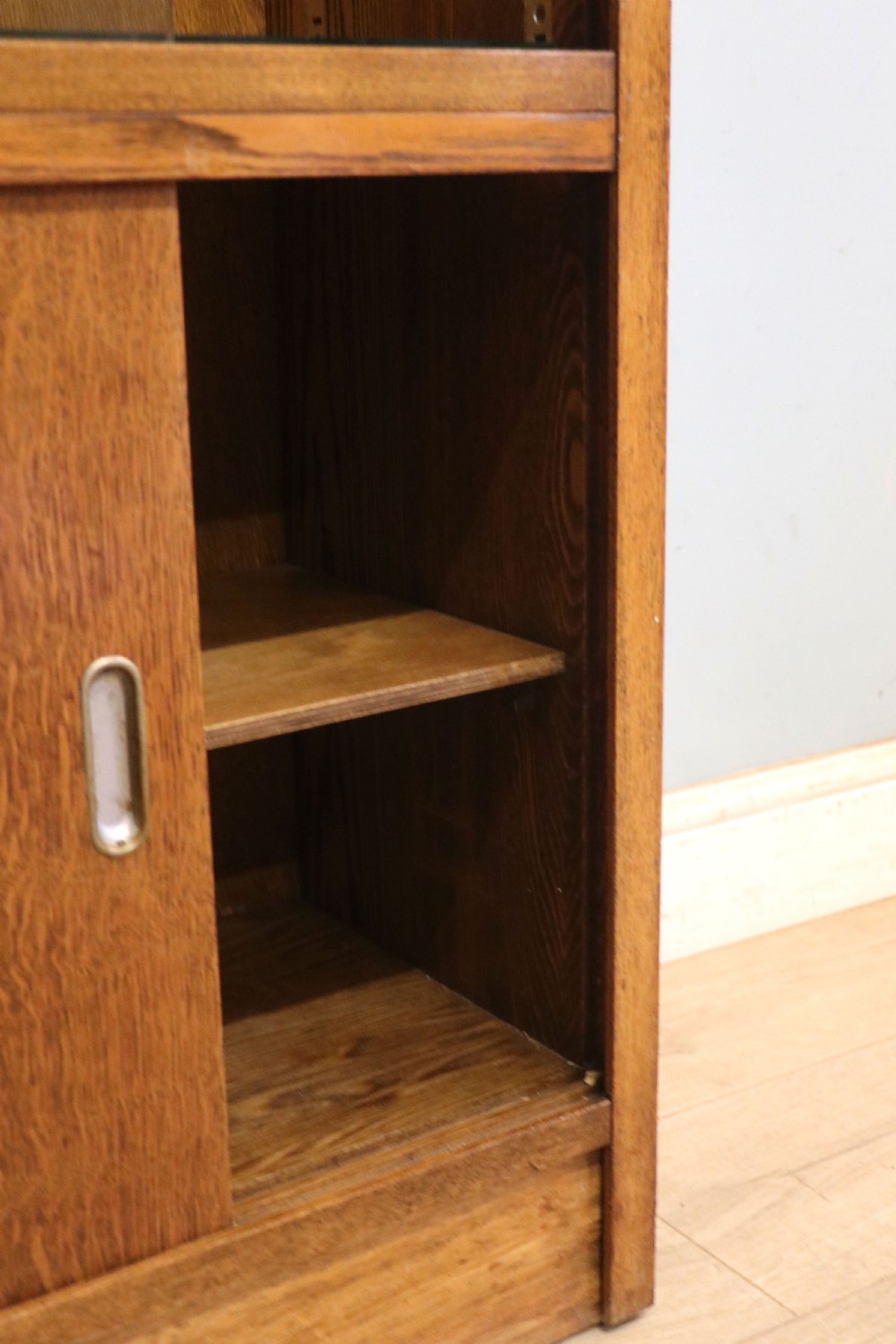  A 1930s/ 1940s oak bookcase or display cabinet decorated with the Associated Television logo. View XIII