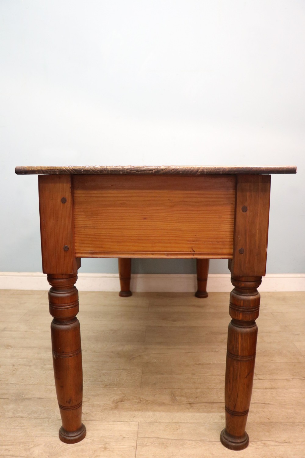 A Victorian stained pine table featuring an elm top and turned legs, shown against a plain background. View III