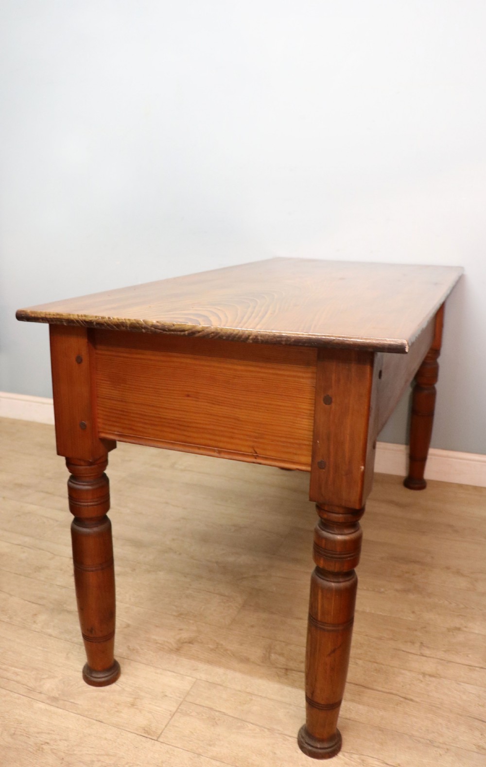 A Victorian stained pine table featuring an elm top and turned legs, shown against a plain background. View V