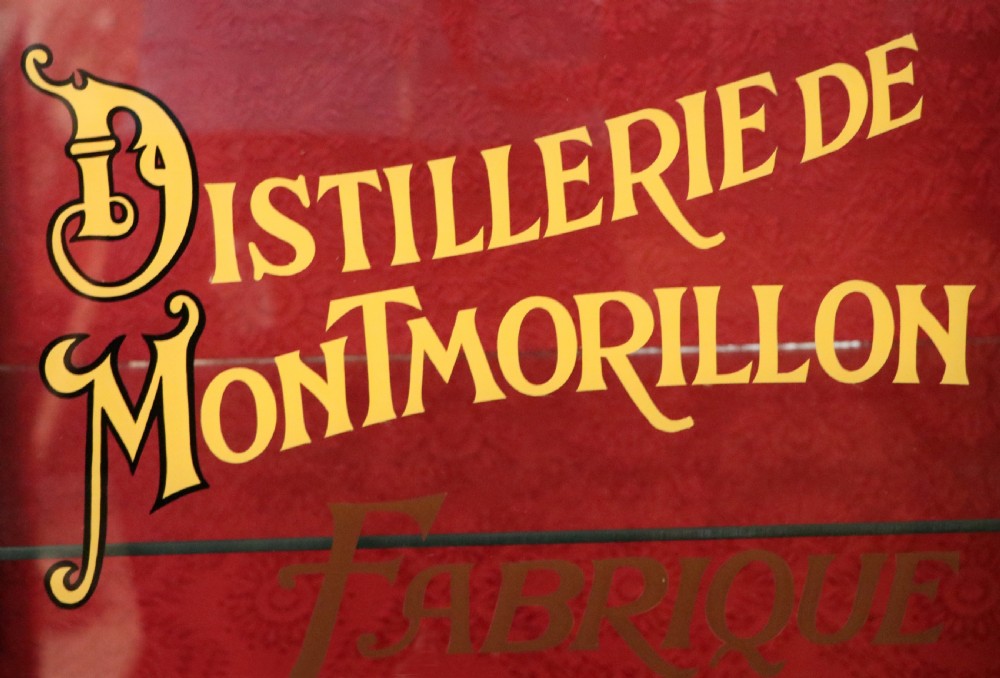 A French Vernis Martin style mahogany vitrine cabinet featuring a brass top gallery, glass shelves, red fabric lining, and a glazed door with gilded lettering. View XVIII