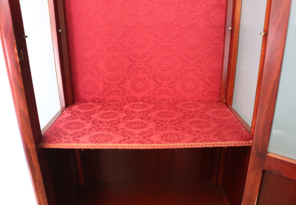 A French Vernis Martin style mahogany vitrine cabinet featuring a brass top gallery, glass shelves, red fabric lining, and a glazed door with gilded lettering. View XXII