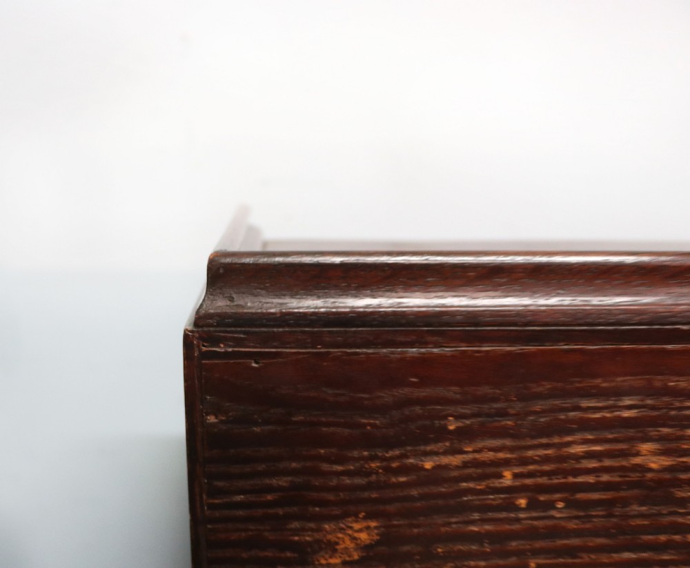 A dark oak fall-front bureau with octagonal geometric cupboard doors, carved details, turned gadrooned feet, and an open fitted stationery compartment. View XXII