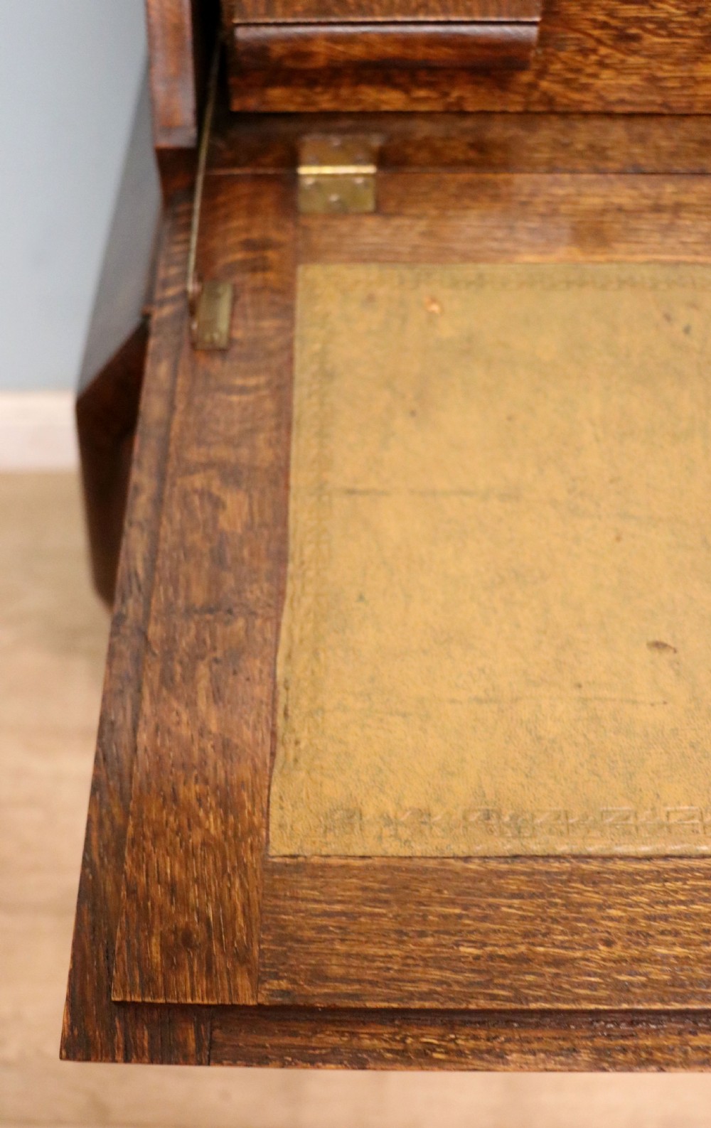A dark oak fall-front bureau with octagonal geometric cupboard doors, carved details, turned gadrooned feet, and an open fitted stationery compartment. View XXIX