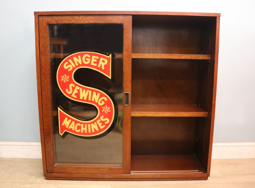 A lovely early 20th century oak framed display cabinet sign written for Singer Sewing Machines. View II