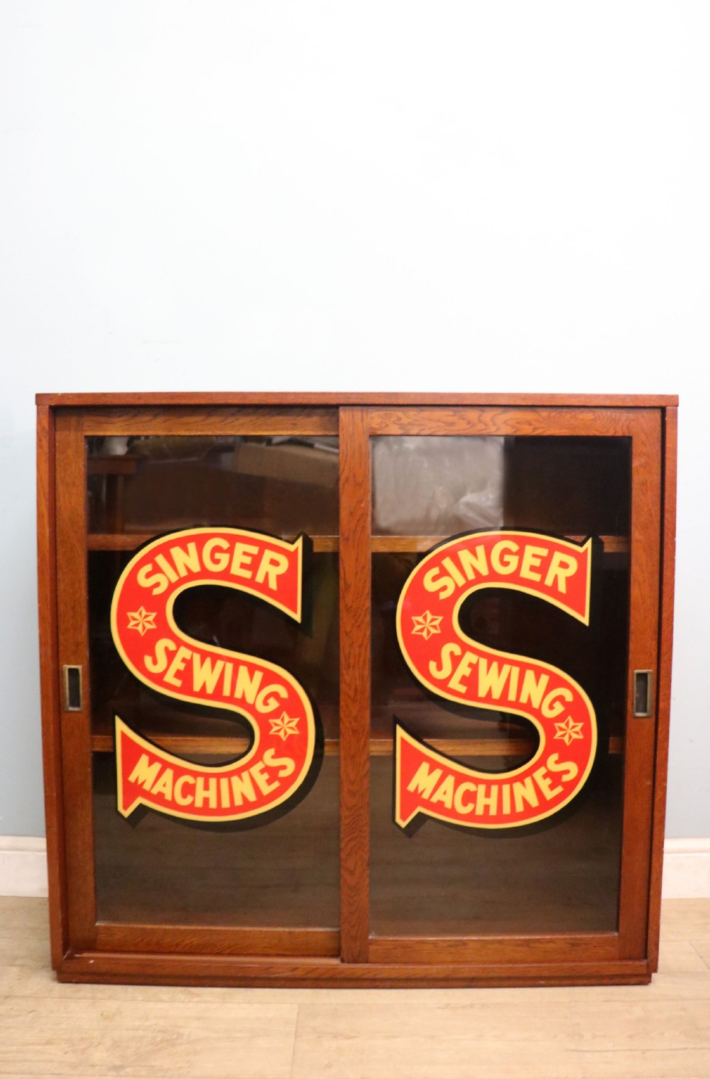 A lovely early 20th century oak framed display cabinet sign written for Singer Sewing Machines. View III