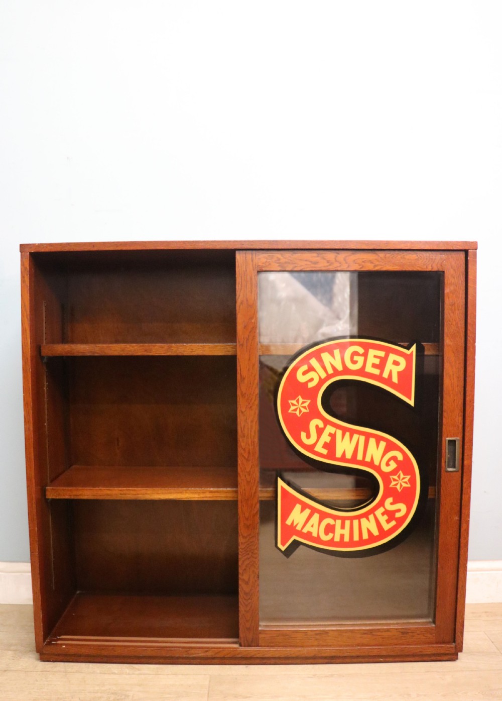 A lovely early 20th century oak framed display cabinet sign written for Singer Sewing Machines. View V