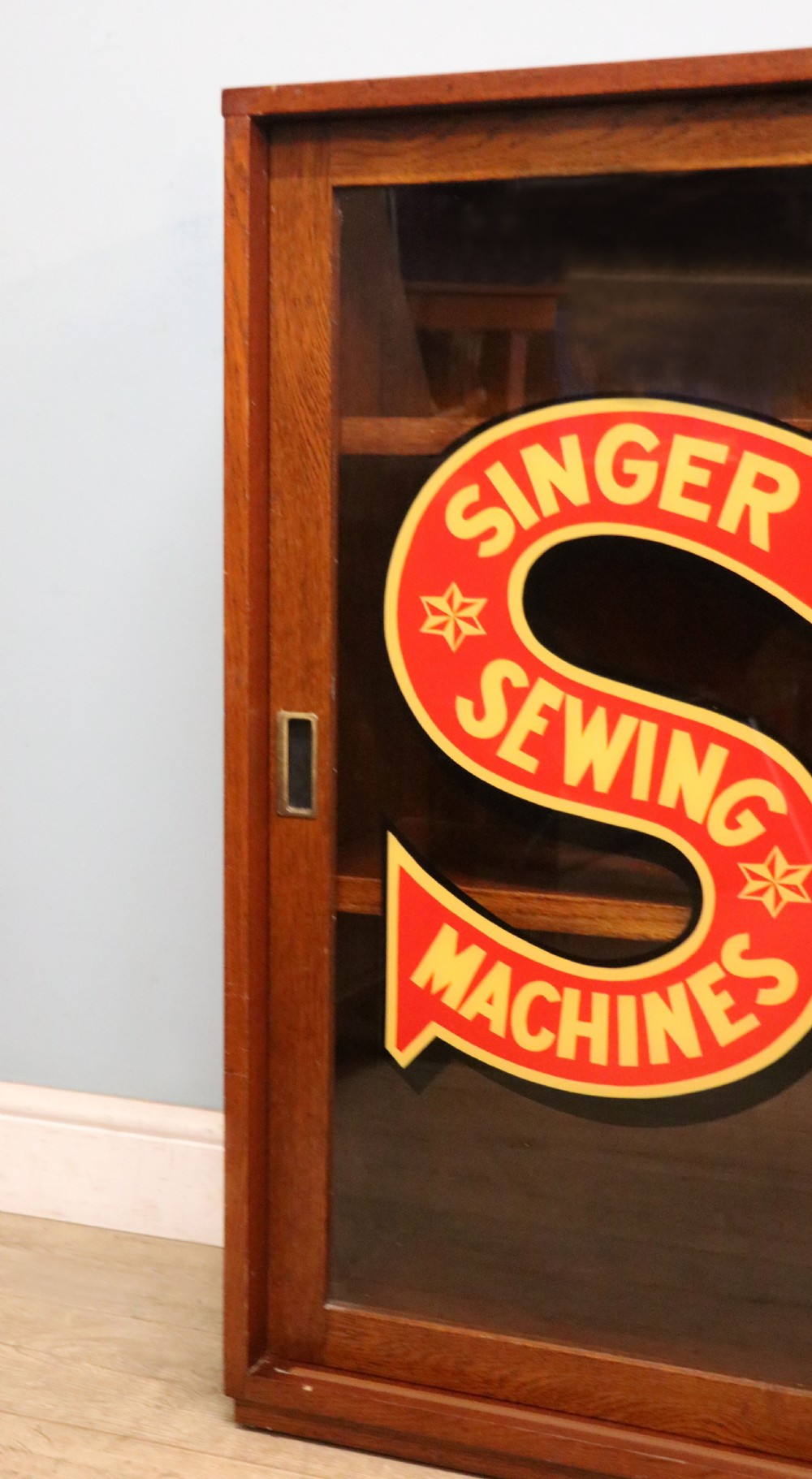 A lovely early 20th century oak framed display cabinet sign written for Singer Sewing Machines. View XII