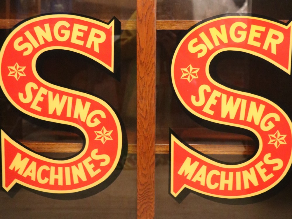 A lovely early 20th century oak framed display cabinet sign written for Singer Sewing Machines. View XIV