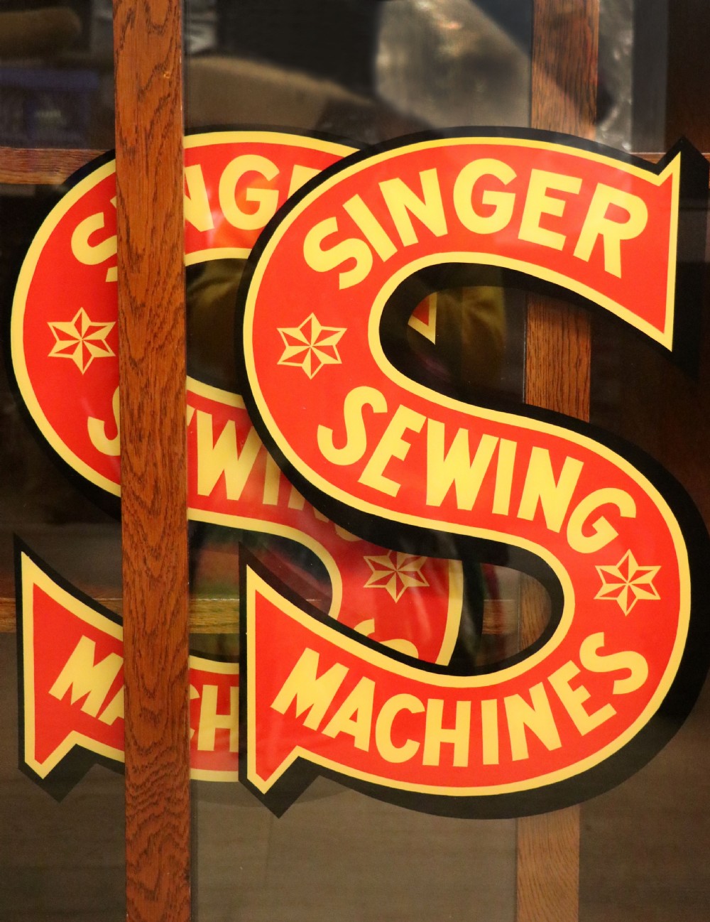 A lovely early 20th century oak framed display cabinet sign written for Singer Sewing Machines. View XVI