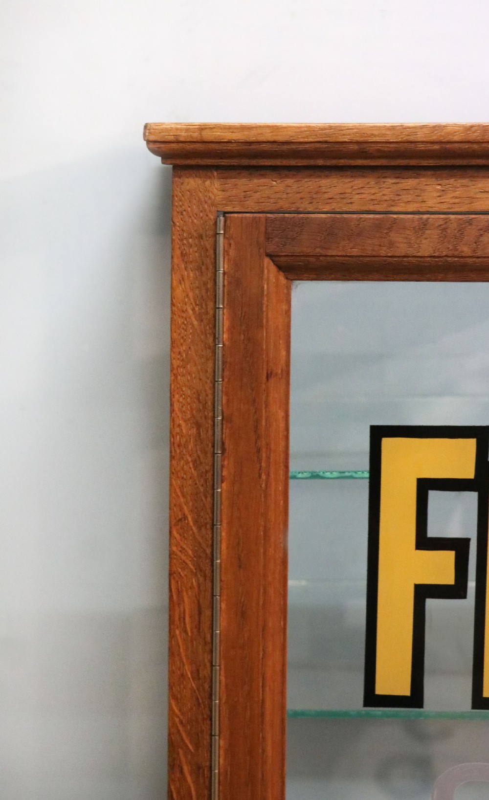 A pair of early 20th-century wooden glazed counter display cabinets featuring sign-written Frys Chocolate lettering on the front glass panels and interior glass shelves. View VIII