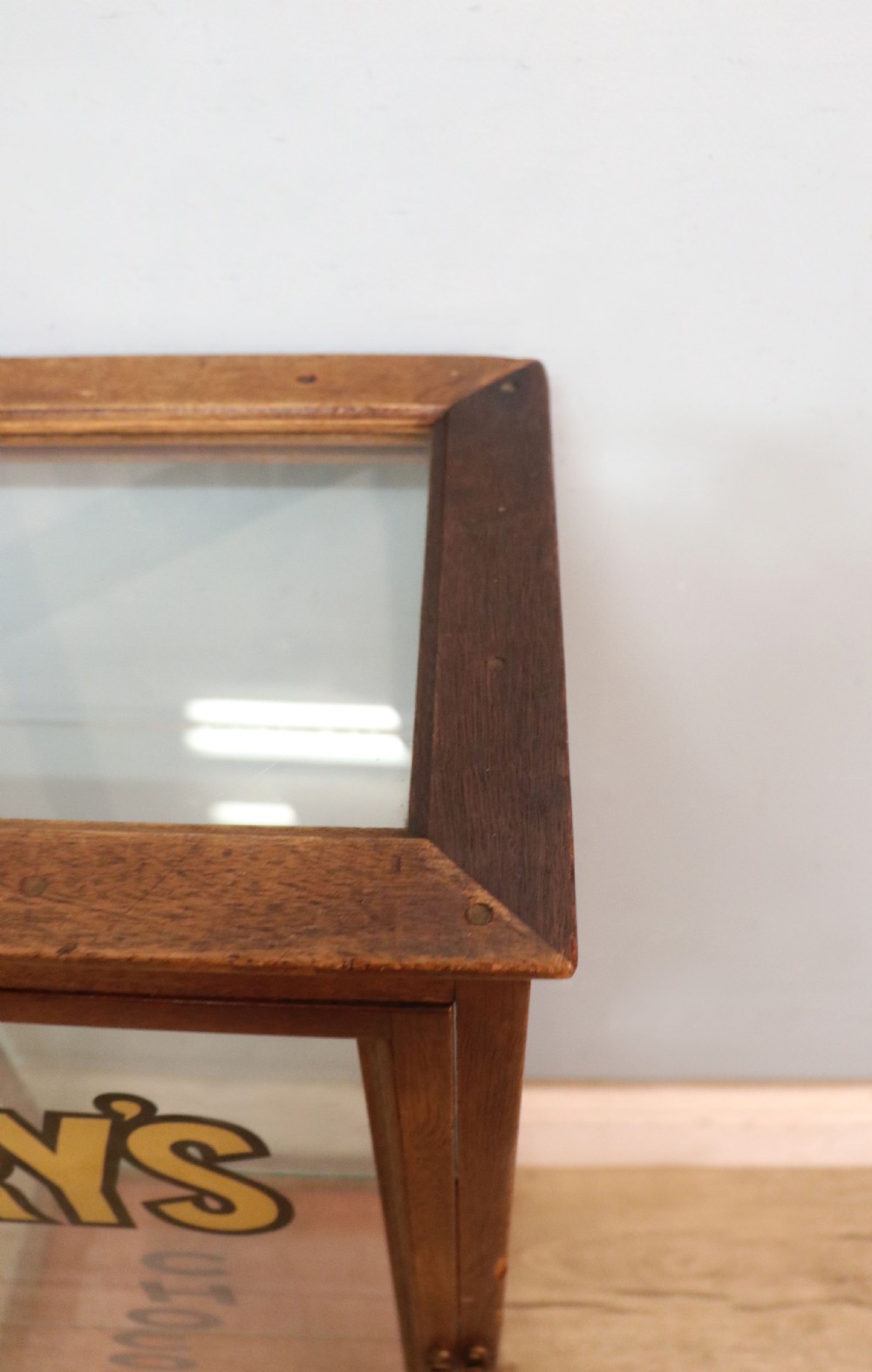 A pair of early 20th-century wooden glazed counter display cabinets featuring sign-written Frys Chocolate lettering on the front glass panels and interior glass shelves. View XI