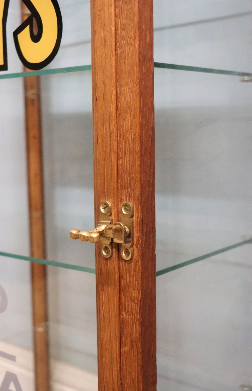A pair of early 20th-century wooden glazed counter display cabinets featuring sign-written Frys Chocolate lettering on the front glass panels and interior glass shelves. View XIV