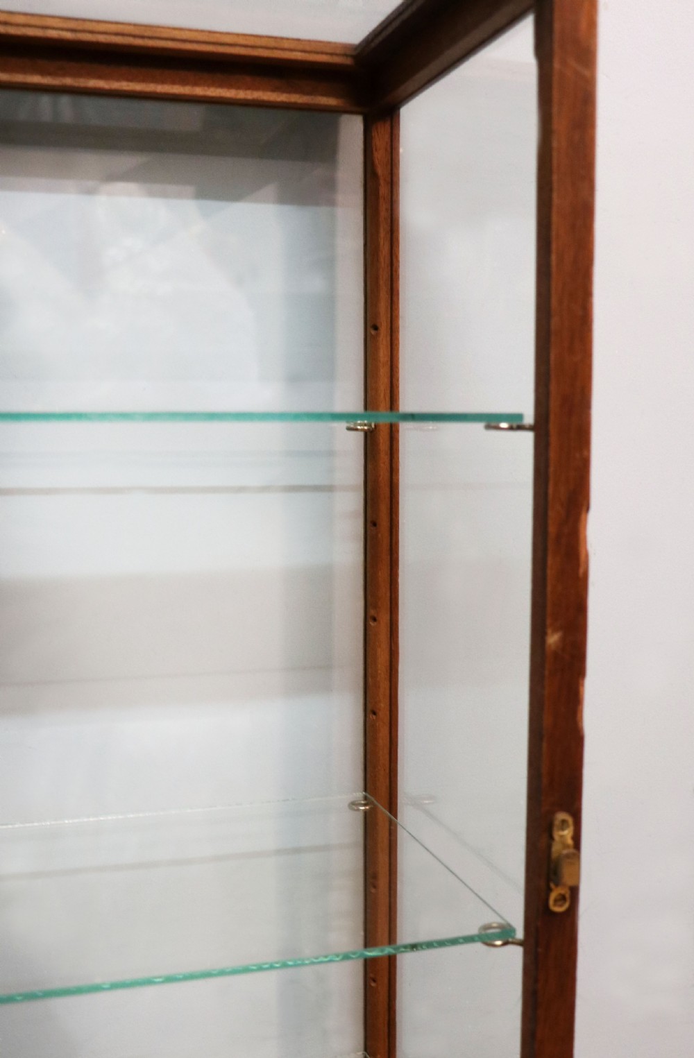 A pair of early 20th-century wooden glazed counter display cabinets featuring sign-written Frys Chocolate lettering on the front glass panels and interior glass shelves. View XVII