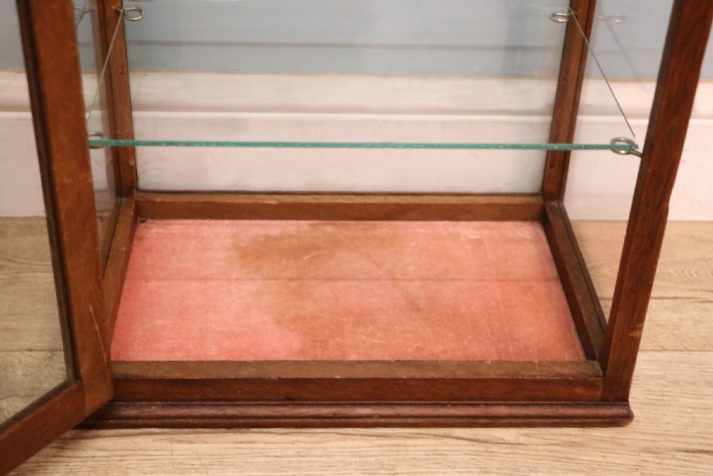A pair of early 20th-century wooden glazed counter display cabinets featuring sign-written Frys Chocolate lettering on the front glass panels and interior glass shelves. View XIX