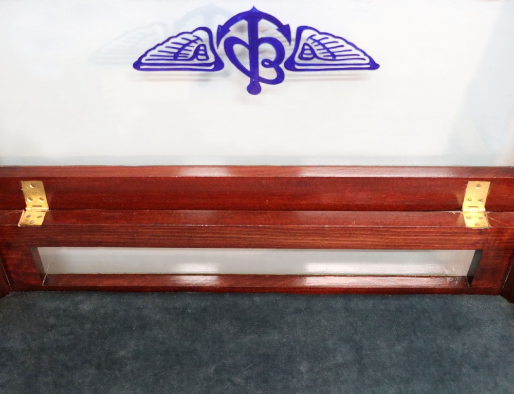 A French Louis XV style glazed bijouterie table in dark hardwood with cabriole legs, gilt metal mounts, and blue Breitling lettering on the glass top. View XXI