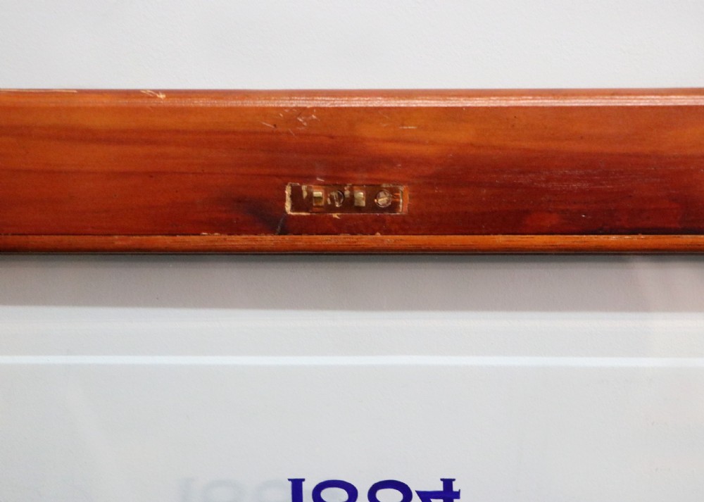 A glazed yew wood bijouterie display table featuring a green velvet interior lining, lower undertier, and Breitling 1884 logo printed on the top glass. View XVI