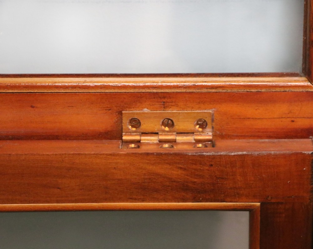A glazed yew wood bijouterie display table featuring a green velvet interior lining, lower undertier, and Breitling 1884 logo printed on the top glass. View XVII