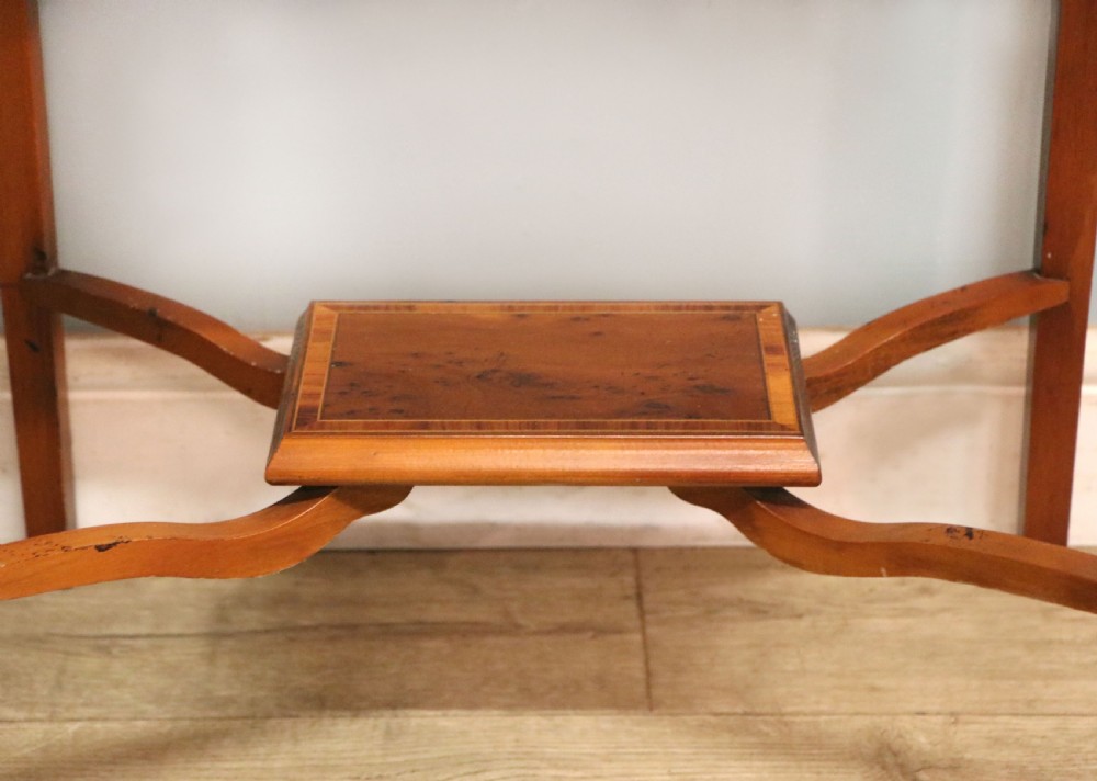 A glazed yew wood bijouterie display table featuring a green velvet interior lining, lower undertier, and Breitling 1884 logo printed on the top glass. View XX