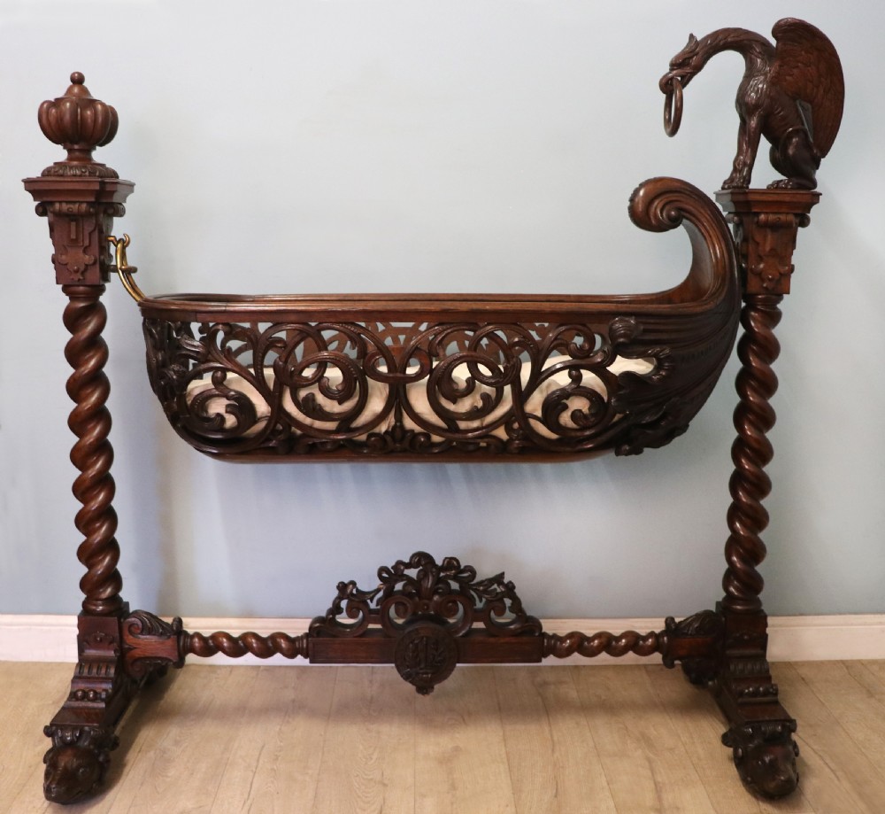 A lovely Victorian rocking baby’s crib with the finest elaborate pierced fretwork oak frame.