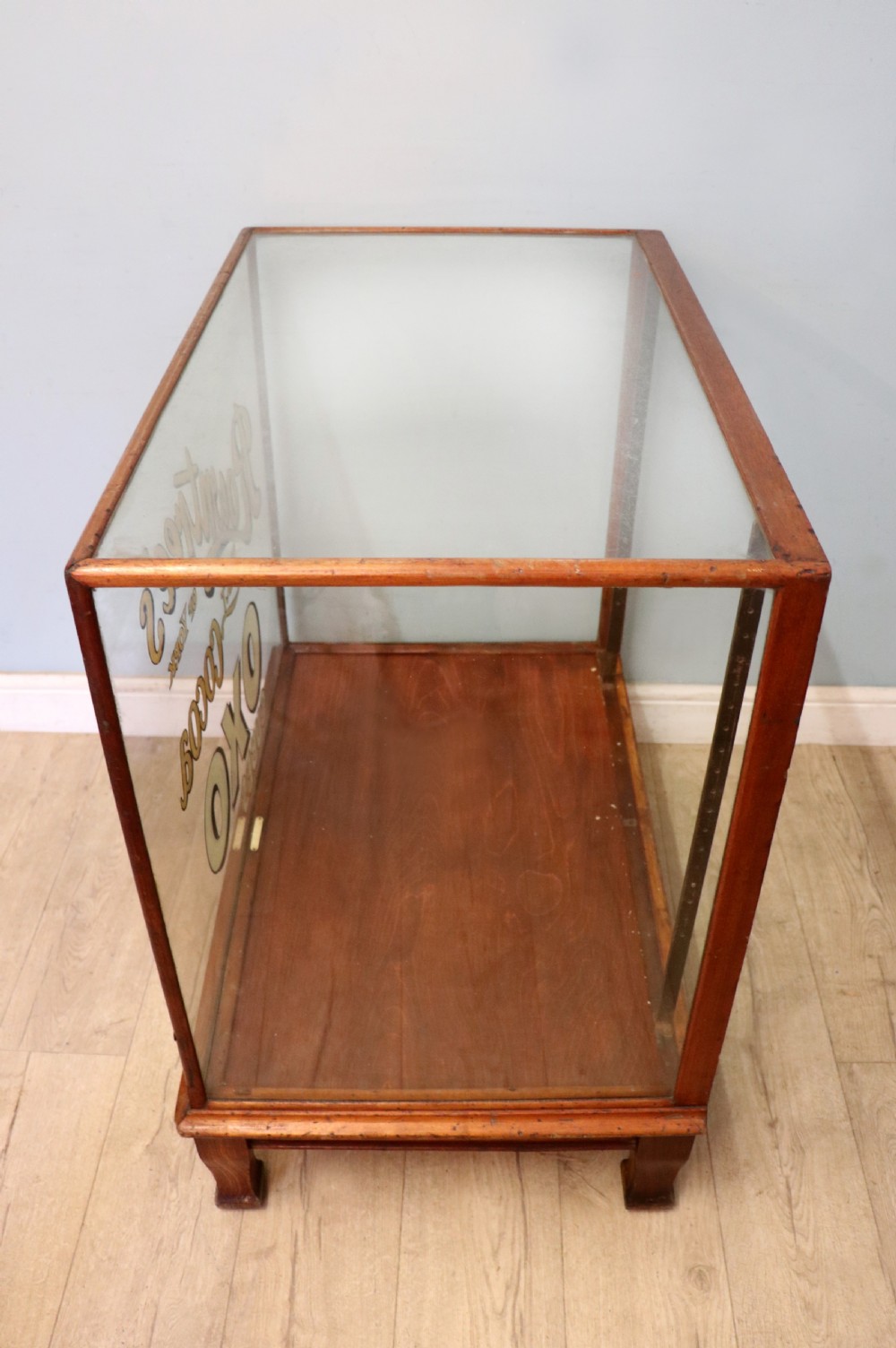 A glazed hardwood countertop display cabinet with sign-written lettering for Rowntrees Elect Cocoa and OXO Cubes on the front glass panel. View IV