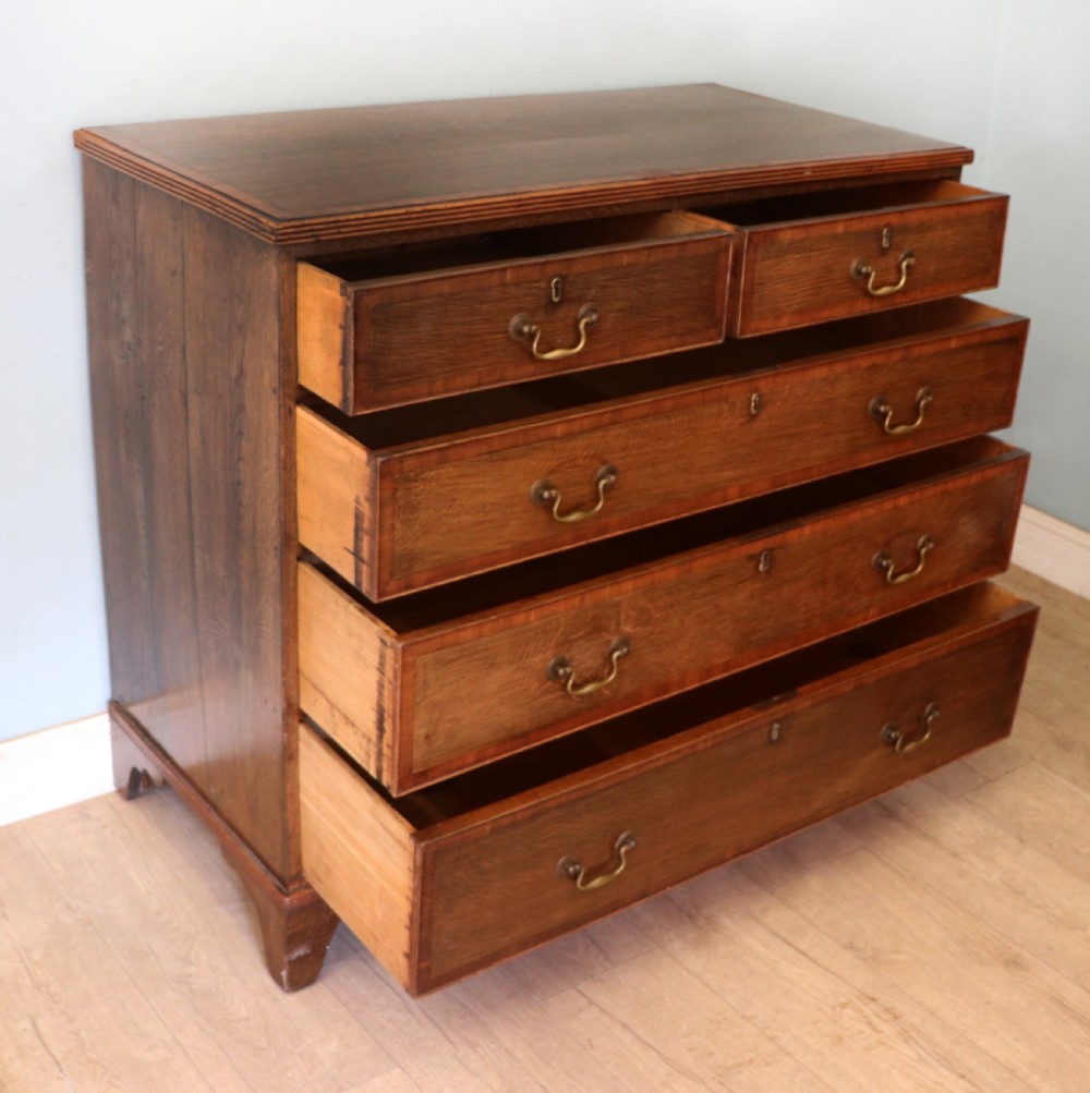 A lovely understated George III oak and mahogany crossbanded chest of drawers.  View III