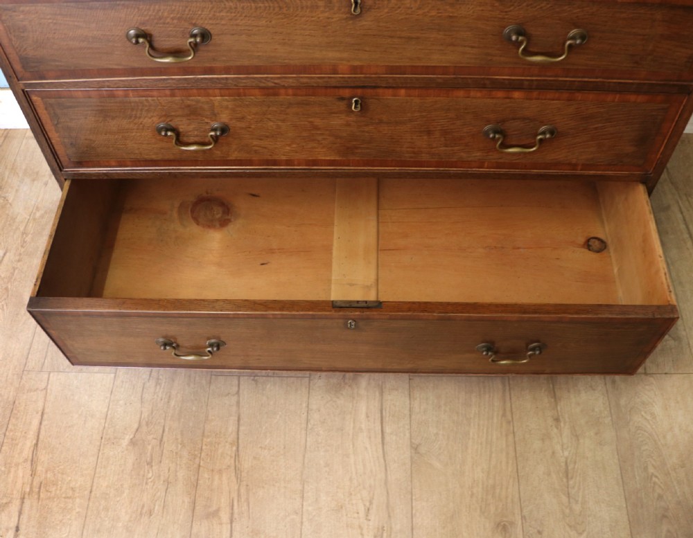 A lovely understated George III oak and mahogany crossbanded chest of drawers.  View XIV
