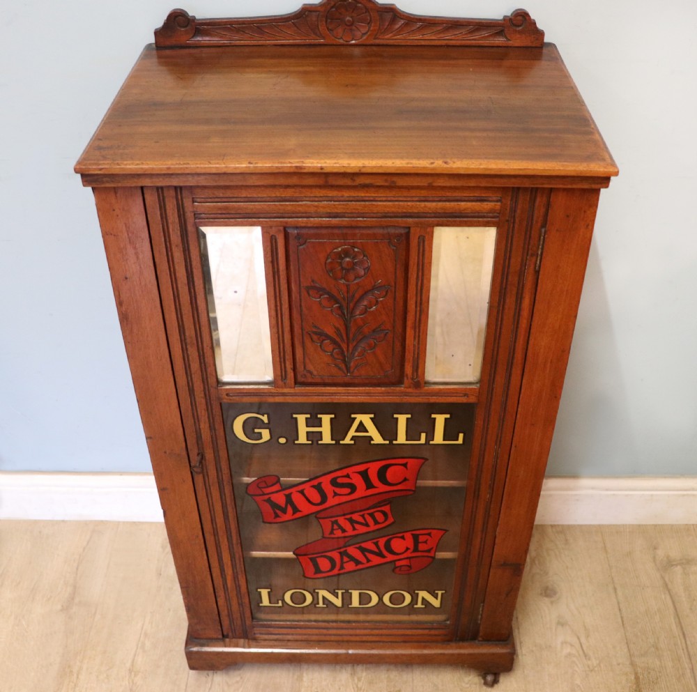 A late Victorian American walnut cabinet, later sign written for G.Hall of London. View II