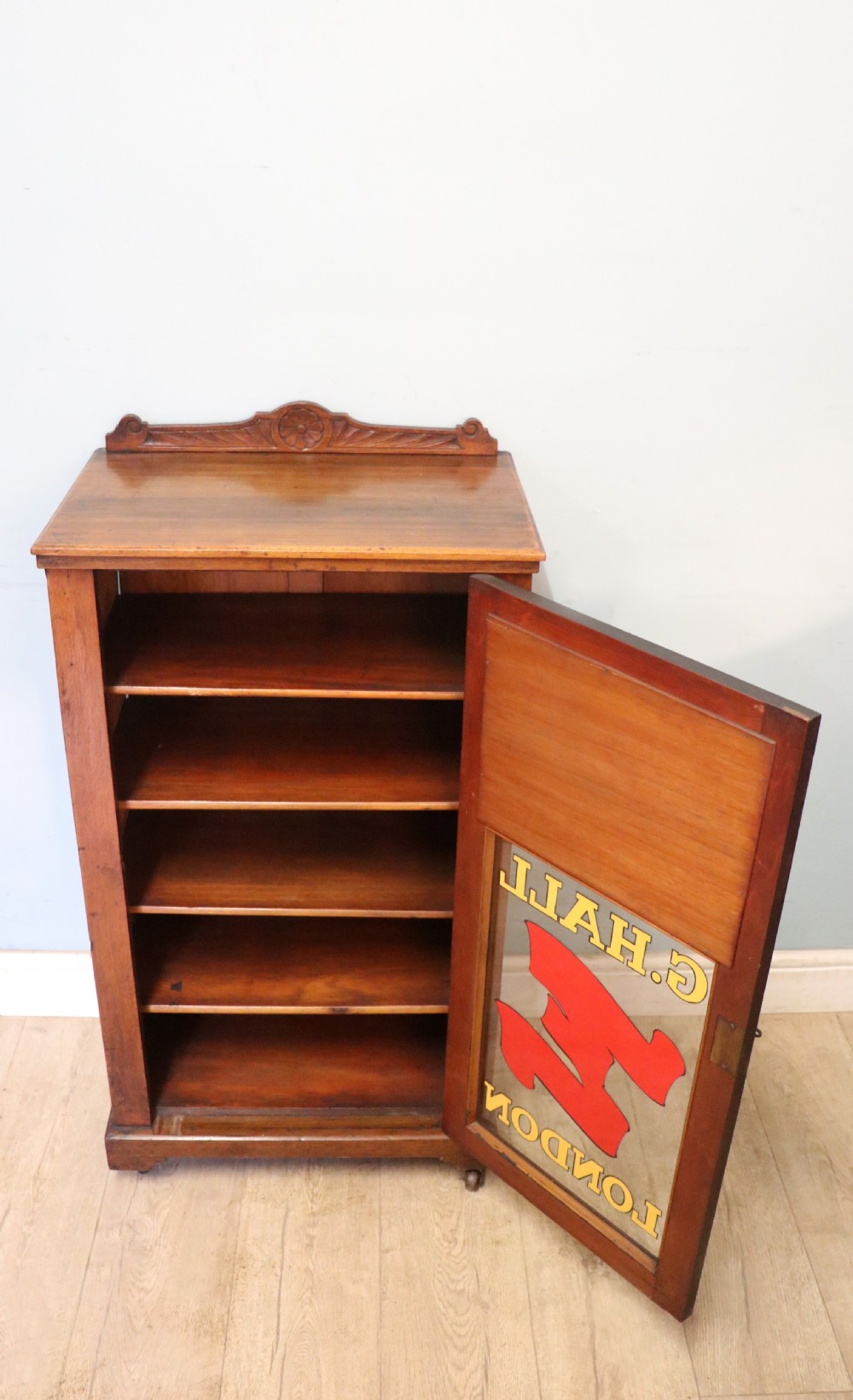 A late Victorian American walnut cabinet, later sign written for G.Hall of London. View III