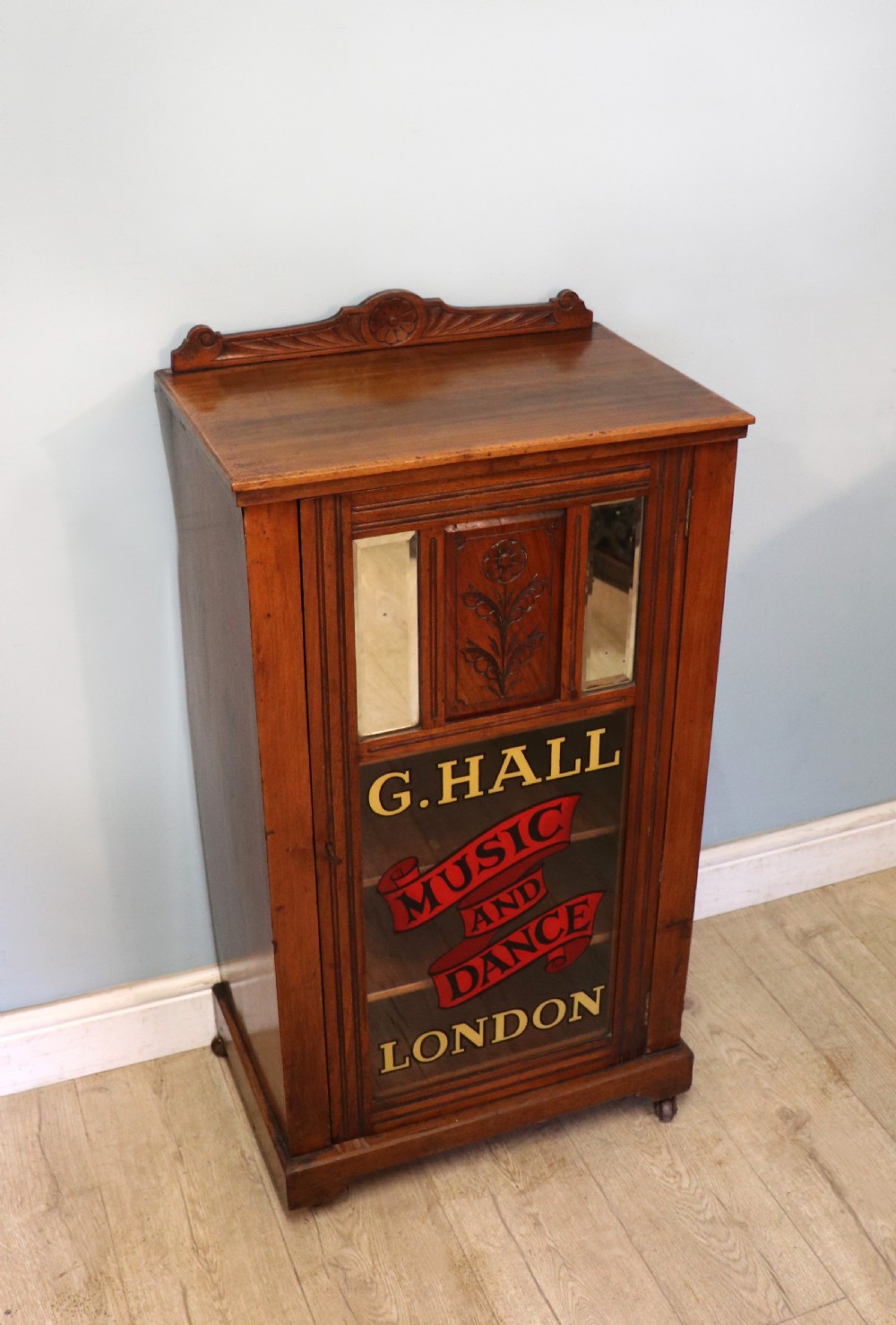 A late Victorian American walnut cabinet, later sign written for G.Hall of London. View IV