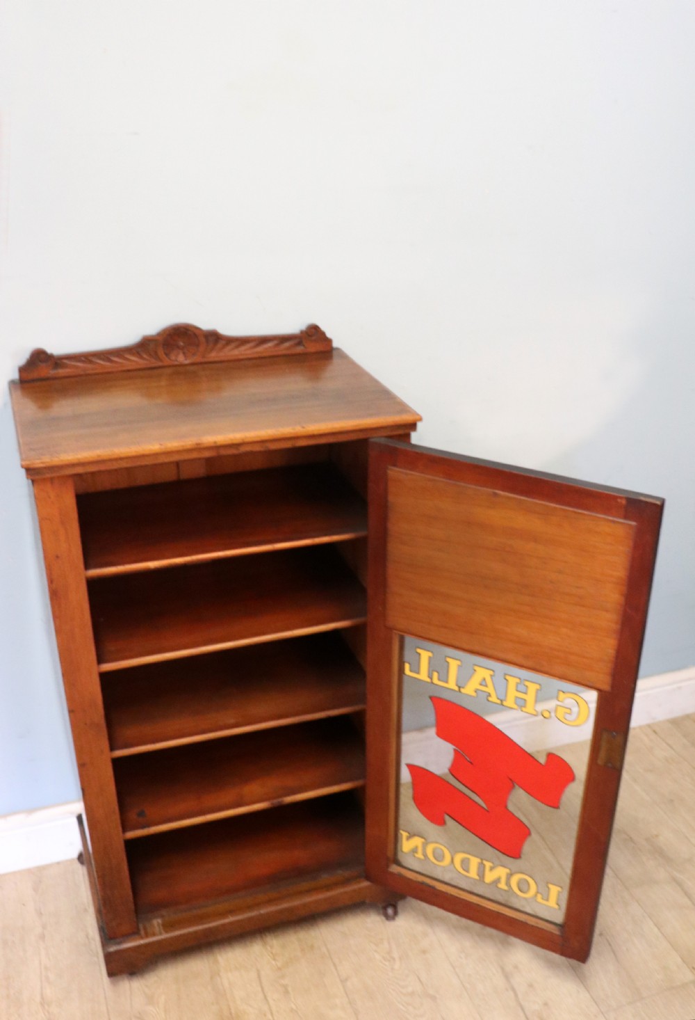 A late Victorian American walnut cabinet, later sign written for G.Hall of London. View V