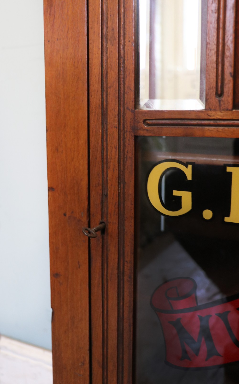 A late Victorian American walnut cabinet, later sign written for G.Hall of London. View XVII