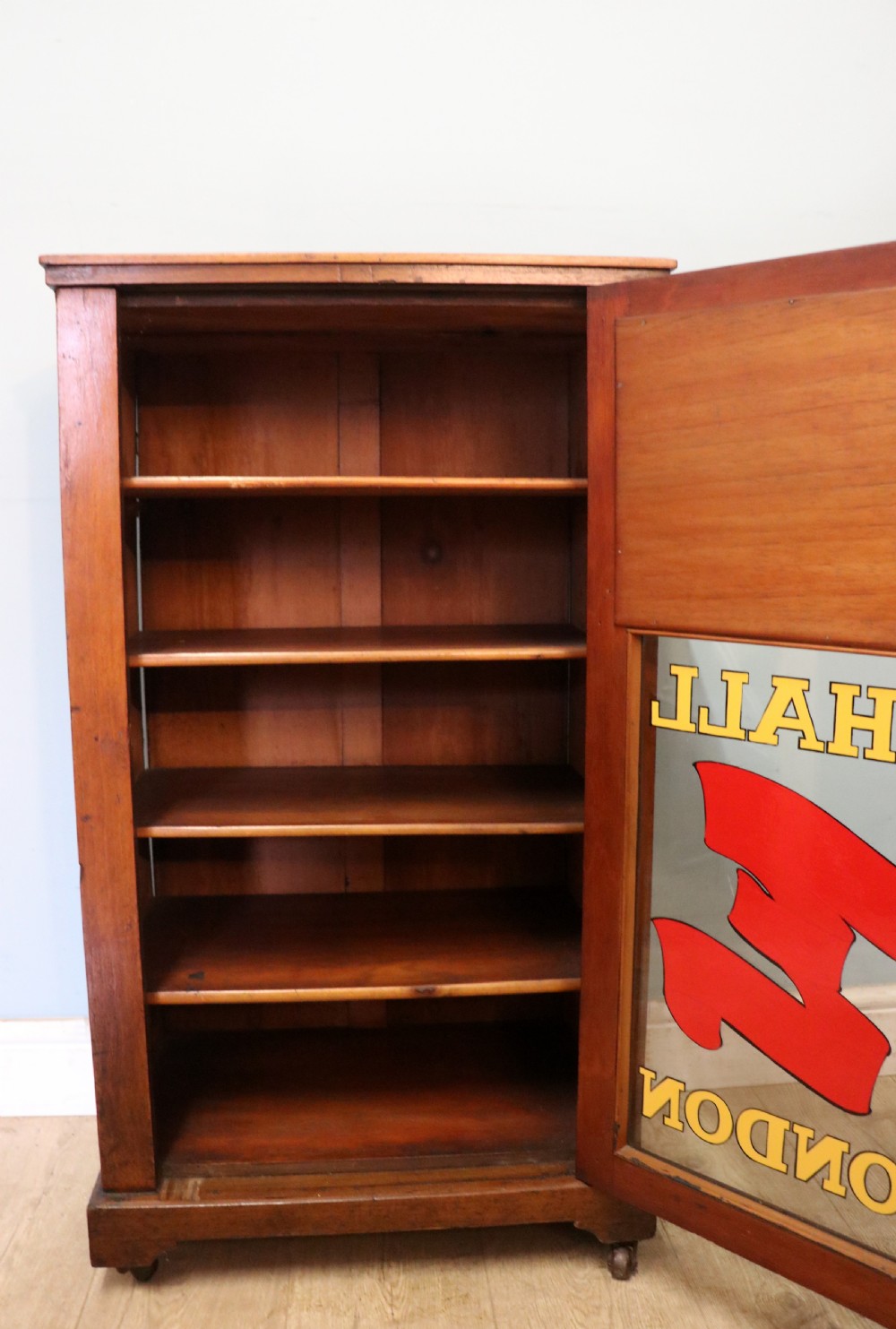 A late Victorian American walnut cabinet, later sign written for G.Hall of London. View XIX