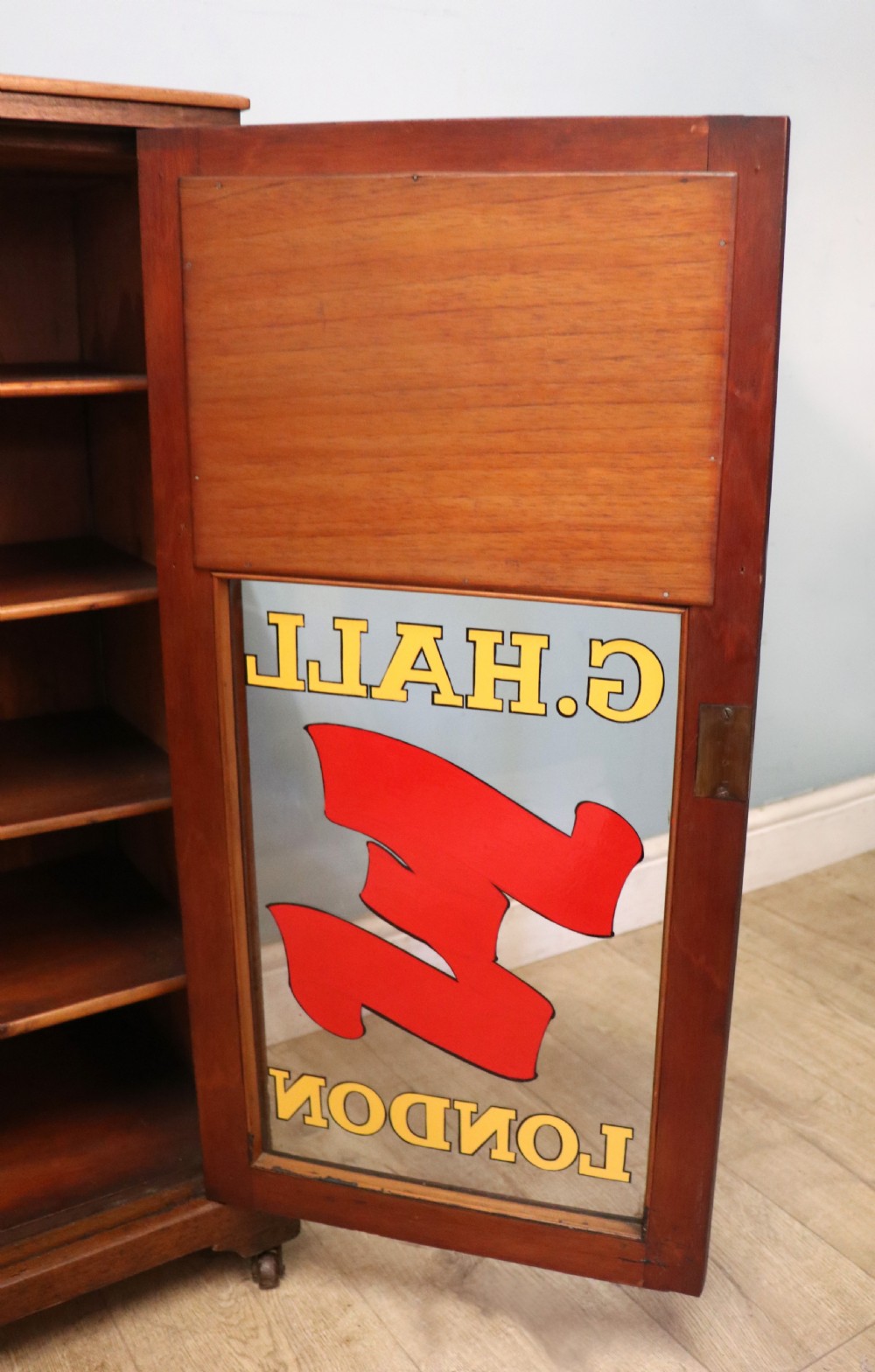 A late Victorian American walnut cabinet, later sign written for G.Hall of London. View XX