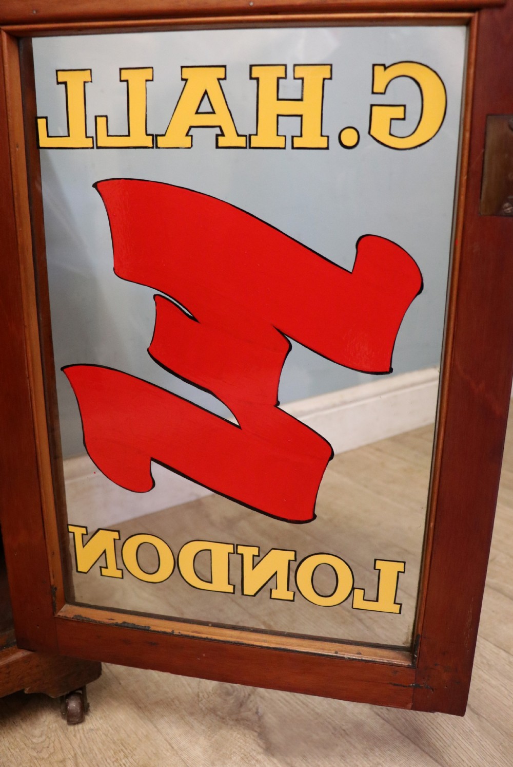 A late Victorian American walnut cabinet, later sign written for G.Hall of London. View XXI