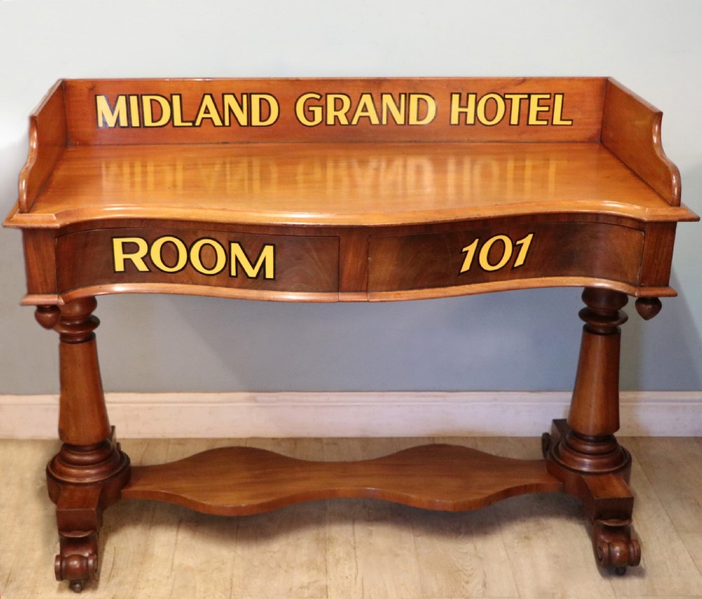 A Victorian mahogany console table with turned legs, a low gallery back, and yellow painted lettering reading Midland Grand Hotel Room 101. View II
