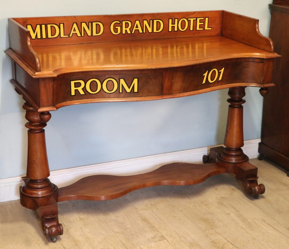 A Victorian mahogany console table with turned legs, a low gallery back, and yellow painted lettering reading Midland Grand Hotel Room 101. View III