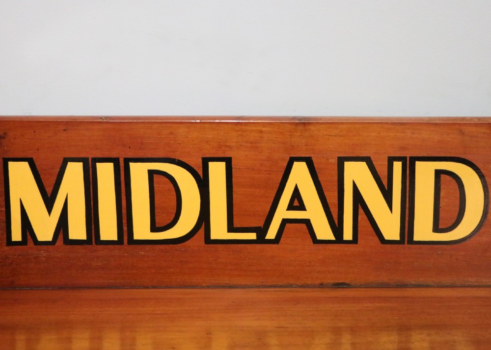 A Victorian mahogany console table with turned legs, a low gallery back, and yellow painted lettering reading Midland Grand Hotel Room 101. View IX