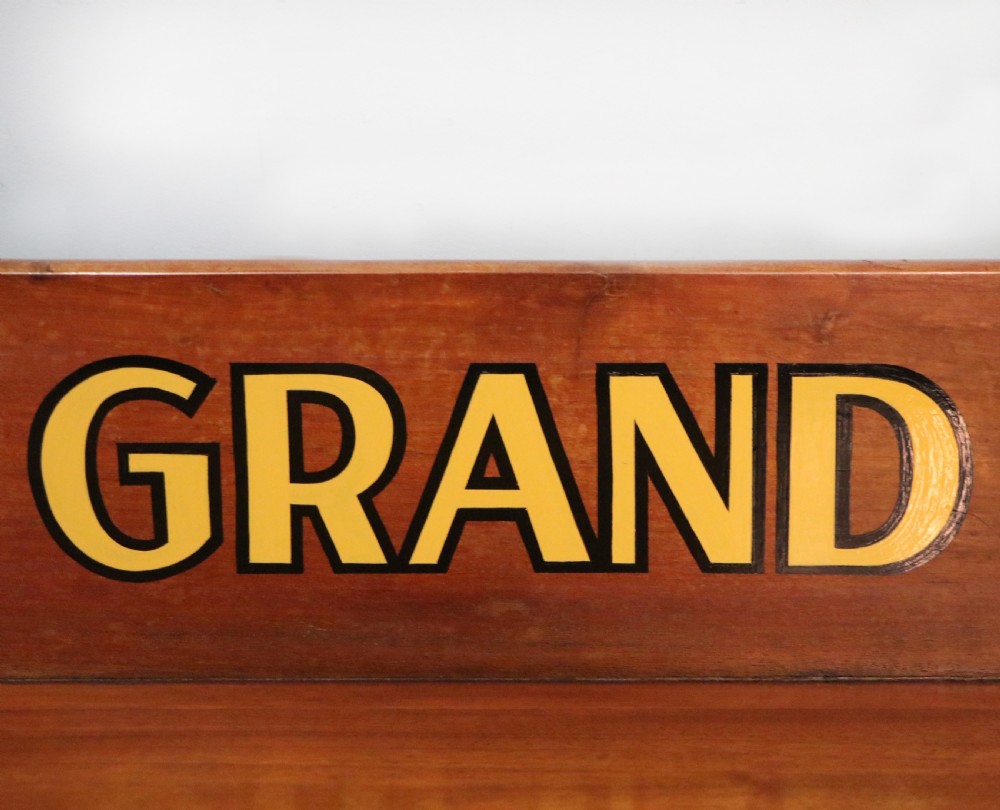 A Victorian mahogany console table with turned legs, a low gallery back, and yellow painted lettering reading Midland Grand Hotel Room 101. View X
