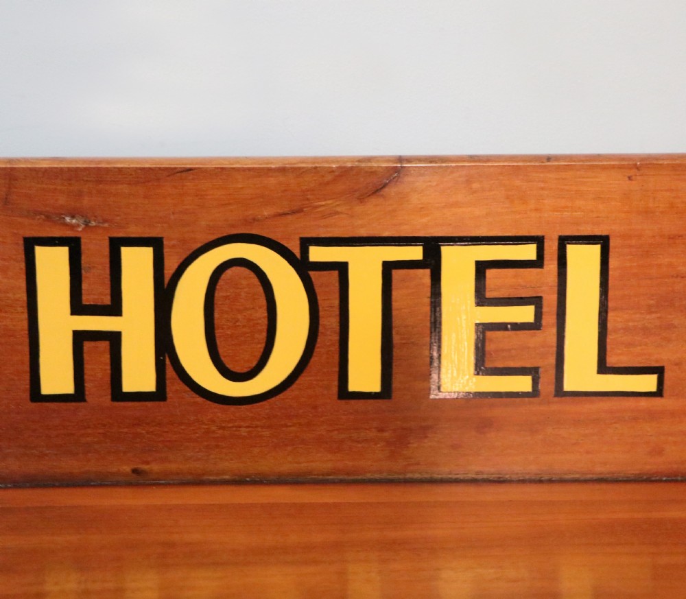 A Victorian mahogany console table with turned legs, a low gallery back, and yellow painted lettering reading Midland Grand Hotel Room 101. View XI