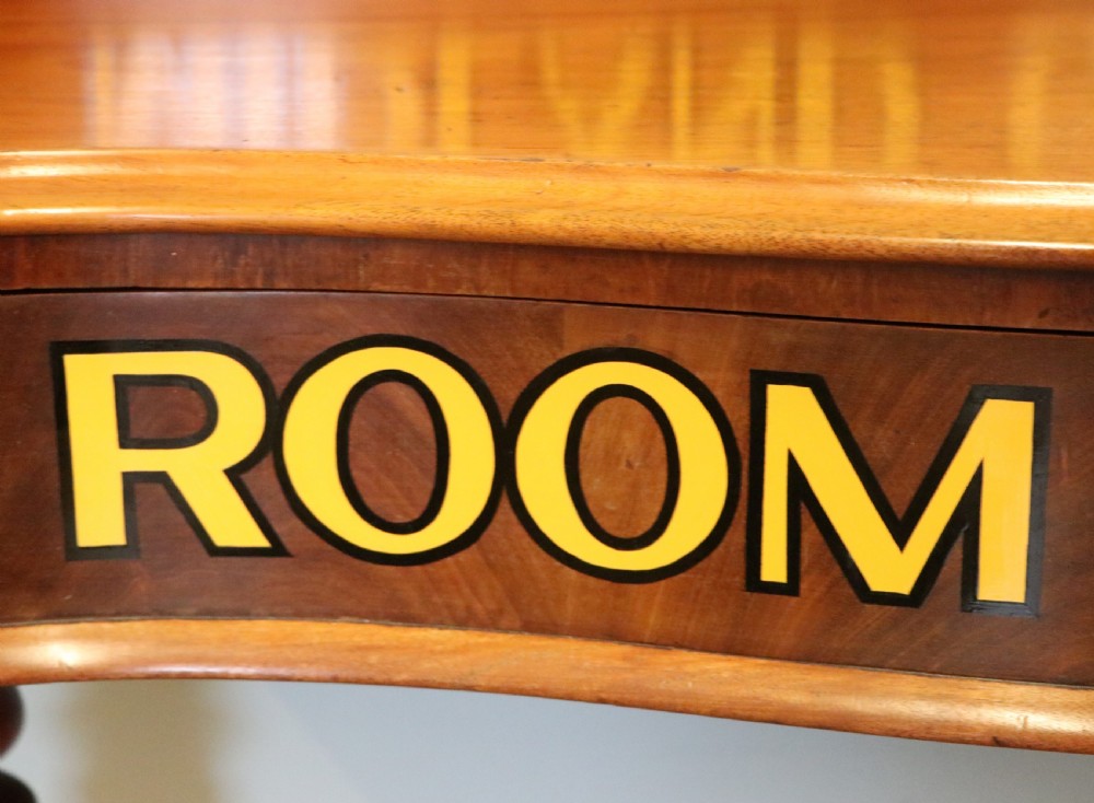 A Victorian mahogany console table with turned legs, a low gallery back, and yellow painted lettering reading Midland Grand Hotel Room 101. View XII