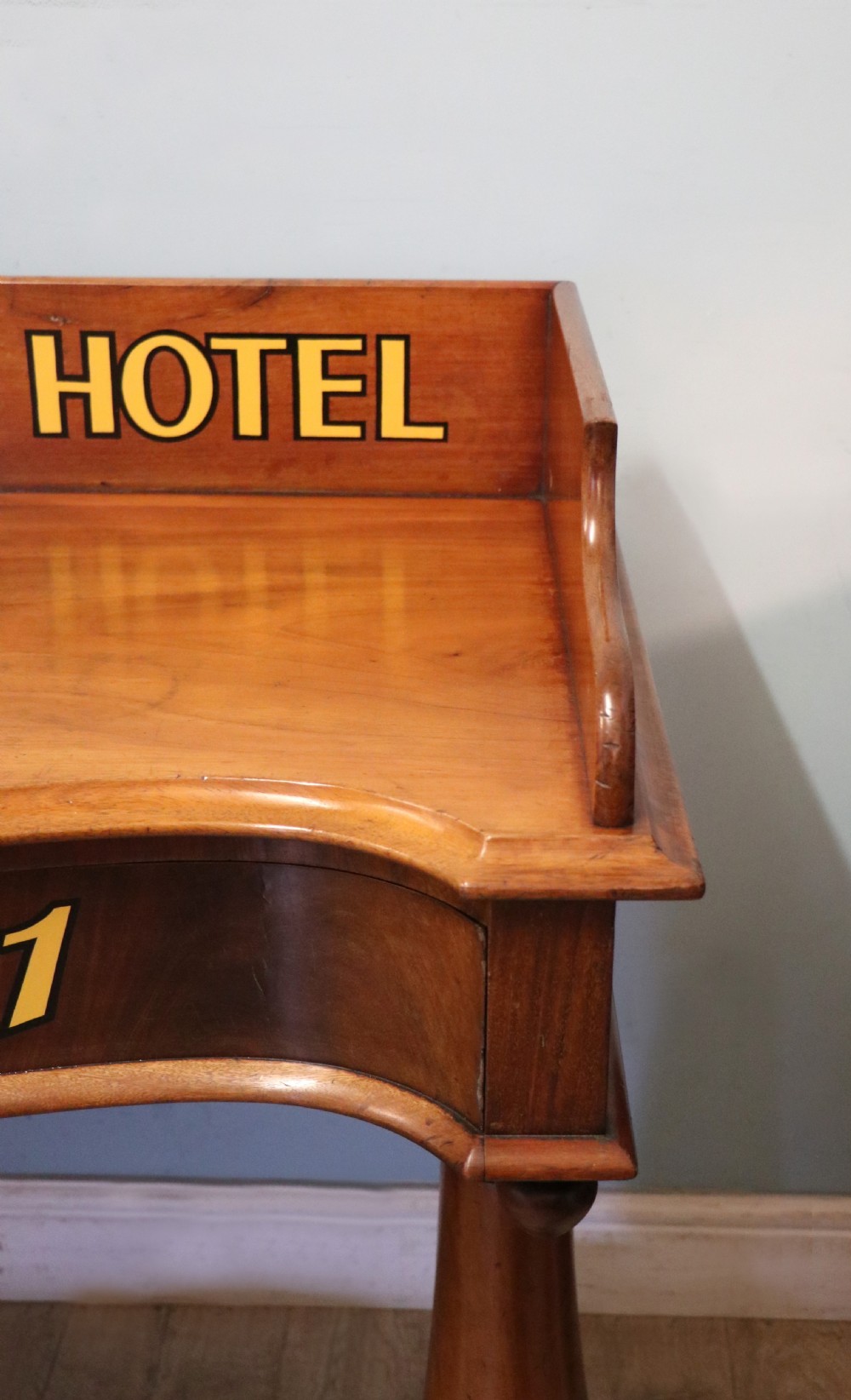 A Victorian mahogany console table with turned legs, a low gallery back, and yellow painted lettering reading Midland Grand Hotel Room 101. View XIV