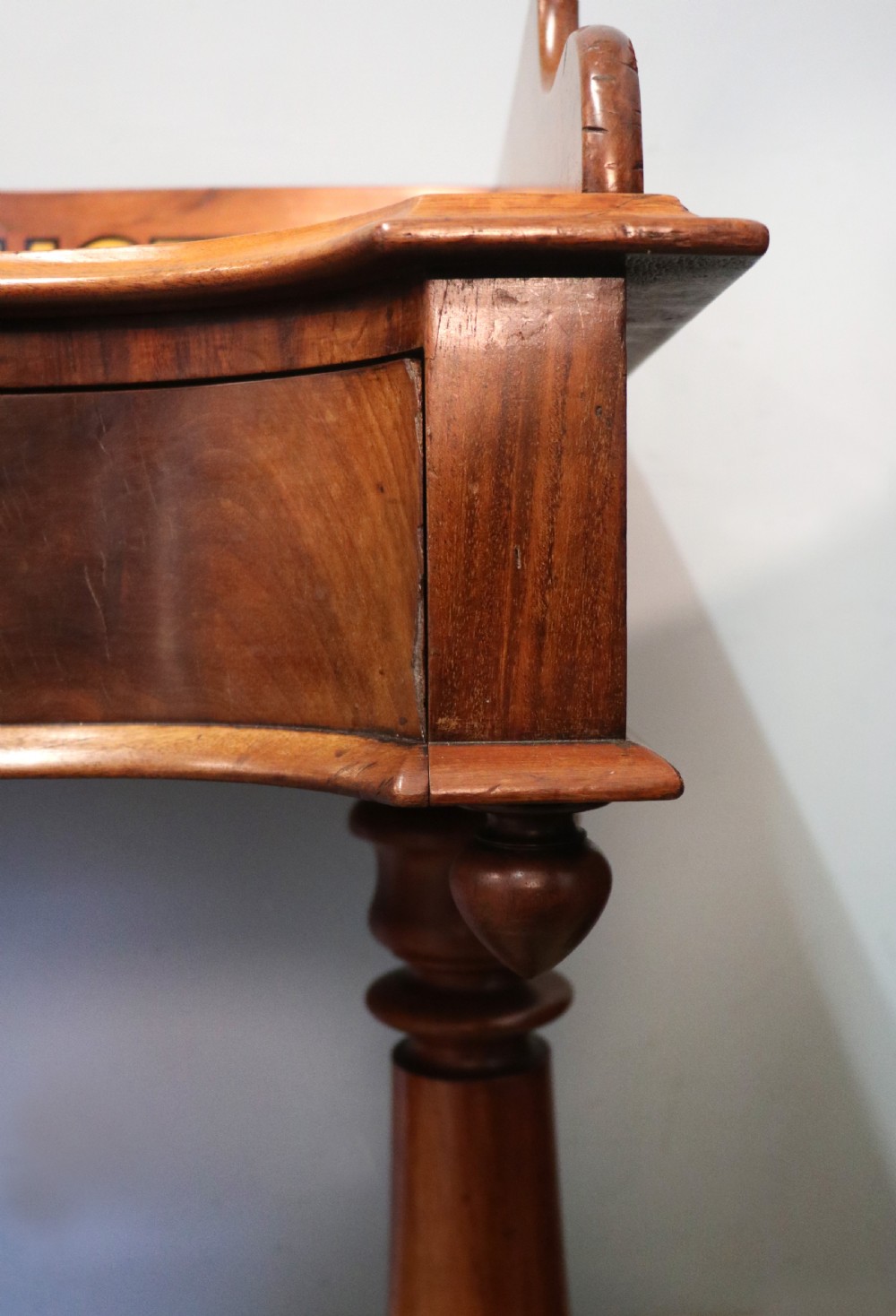 A Victorian mahogany console table with turned legs, a low gallery back, and yellow painted lettering reading Midland Grand Hotel Room 101. View XVI