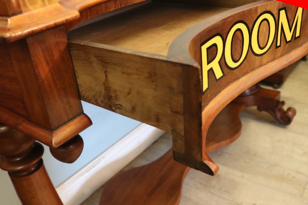 A Victorian mahogany console table with turned legs, a low gallery back, and yellow painted lettering reading Midland Grand Hotel Room 101. View XX