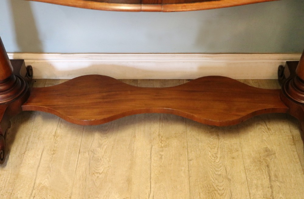 A Victorian mahogany console table with turned legs, a low gallery back, and yellow painted lettering reading Midland Grand Hotel Room 101. View XXI