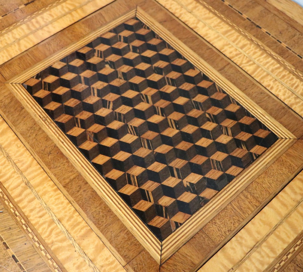 A late Victorian wooden occasional table featuring a geometric parquetry inlaid top, slender cabriole legs, and a lower glazed smokers cabinet. View VI