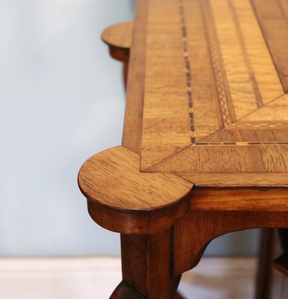A late Victorian wooden occasional table featuring a geometric parquetry inlaid top, slender cabriole legs, and a lower glazed smokers cabinet. View XI